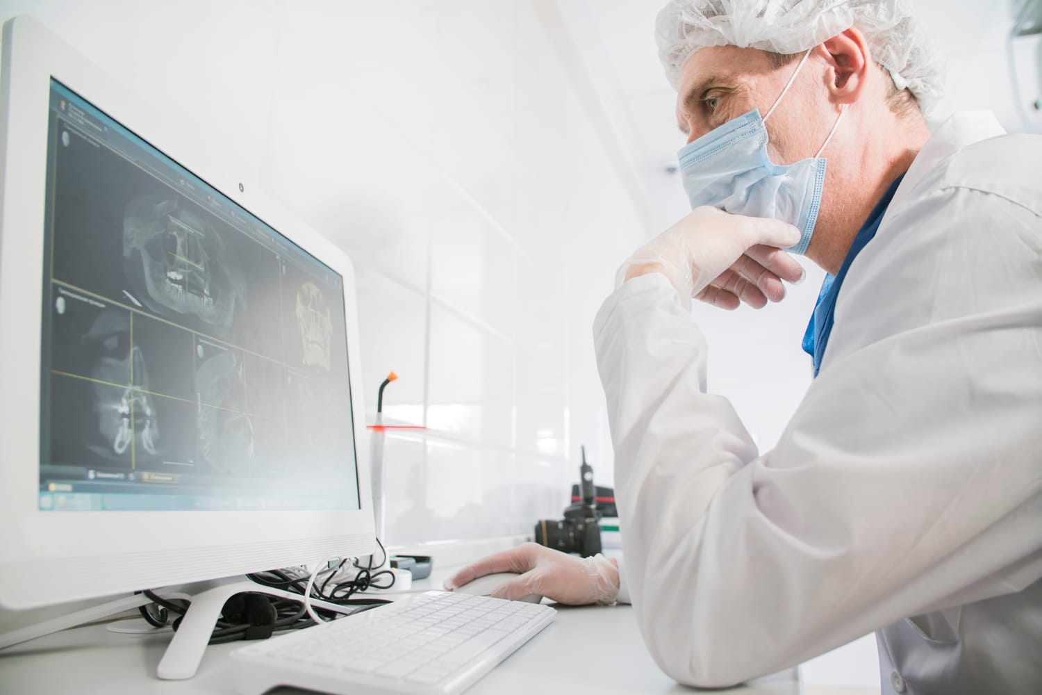 Medical researcher studying X-rays of a person's jaw